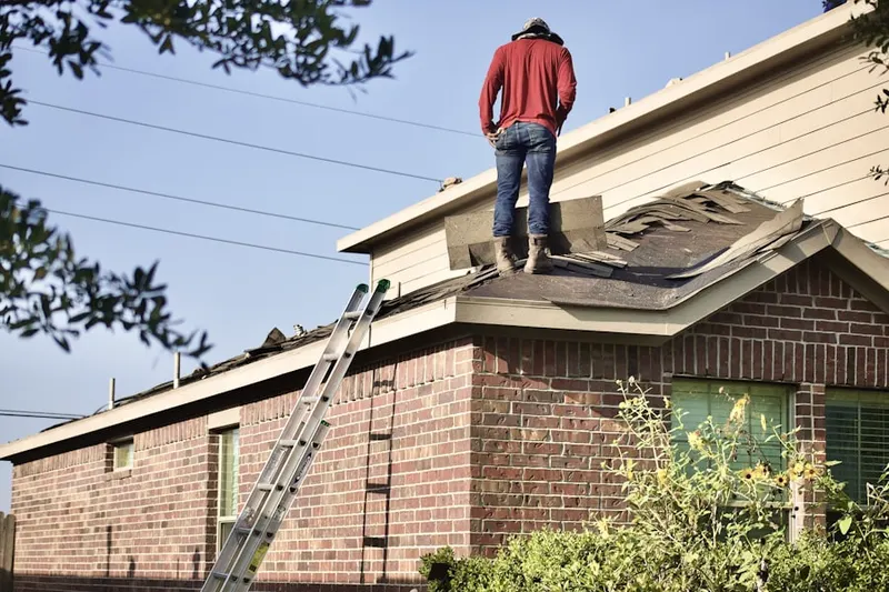 Professional roofer working on a residential roof in Hickory Square